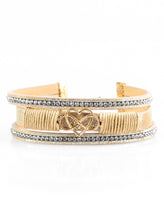 Load image into Gallery viewer, Metallic tan leather strands layer across the wrist. Infused with rows of white rhinestones, tan cording knots around the centermost strand, securing an airy gold heart and infinity charm in place for a whimsical finish. Features an adjustable clasp closure.  Sold as one individual bracelet.