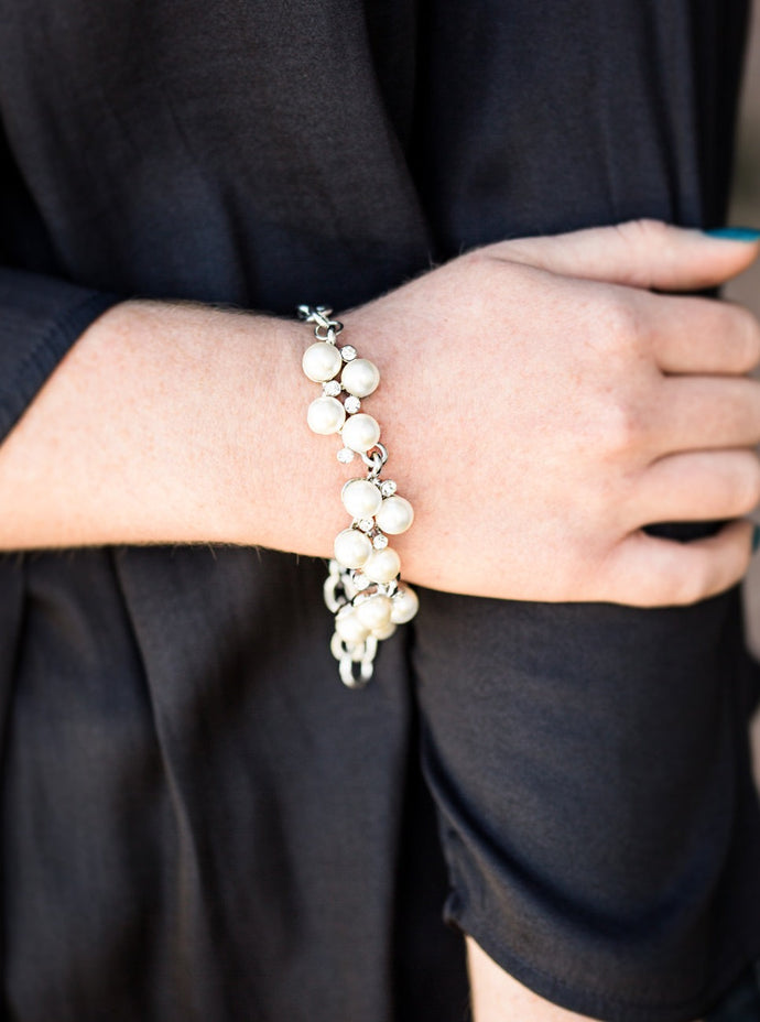 Small clusters of shimmery white pearls are dusted with sparkling rhinestones, creating a romantic timeless design. Features an adjustable clasp closure.  Sold as one individual bracelet.