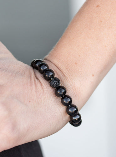 Shiny black beads are threaded along a stretchy elastic band. Encrusted in black rhinestones, glittery accents are added to the classic beading for an edgy look.  Sold as one individual bracelet.