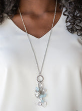 Load image into Gallery viewer, A silver bird charm, silver heart charms, and collection of white pearls and opaque blue crystal-like beads swing from the bottom of a lengthened silver chain for a whimsically clustered look. Features an adjustable clasp closure.  Sold as one individual necklace. Includes one pair of matching earrings.  