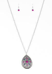 A dramatic teardrop pendant swings from the bottom of an elongated silver chain, elegantly slimming the torso. Glittery blue and pink rhinestones are sprinkled along the pendant as silver filigree dances across the center, creating a regal floral pattern. Features an adjustable clasp closure.  Sold as one individual necklace. Includes one pair of matching earrings.