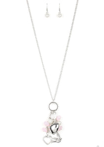 A silver bird charm, silver heart charms, and collection of white pearls and opaque pink crystal-like beads swing from the bottom of a lengthened silver chain for a whimsically clustered look. Features an adjustable clasp closure.  Sold as one individual necklace. Includes one pair of matching earrings.+- ./