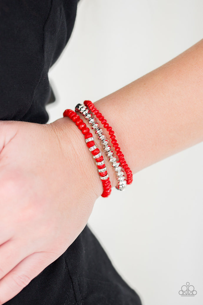 A collection of faceted red and silver beads are threaded along stretchy bands around the wrist. White rhinestone encrusted rings are added to one strand for a refined finish.  Sold as one set of three bracelets.  Always nickel and lead free.