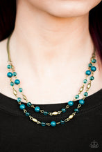 Load image into Gallery viewer, Rustic blue beads trickle along two strands of shimmery brass chain. Infused with shiny brass beading, blue crystal like beads trickle between the colorful accents, creating whimsical layers below the collar. Features an adjustable clasp closure.   Sold as one individual necklace. Includes one pair of matching earrings.   Always nickel and lead free.