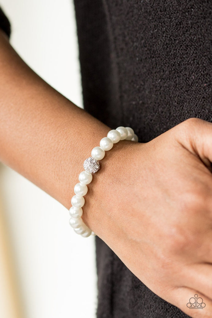 Pearly white beads are threaded along an elastic stretchy band. Encrusted in radiant white rhinestones, a textured silver bead is added to the refined palette, creating a timeless centerpiece atop the wrist.  Sold as one individual bracelet.  Always nickel and lead free.
