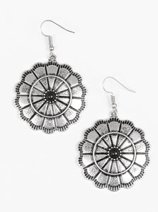 Shimmery silver petals bloom from a black center for a seasonal look. Etched in serrated edges, alternating petals have been delicately hammered in texture, adding depth and shimmer to the whimsical frame. Earring attaches to a standard fishhook fitting.  Sold as one pair of earrings.