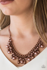 Varying in size, pearly copper beads and faceted copper teardrops drip from the bottoms of interlocking copper chains, creating a bold industrial fringe below the collar. Features an adjustable clasp closure.  Sold as one individual necklace. Includes one pair of matching earrings.  Always nickel and lead free.