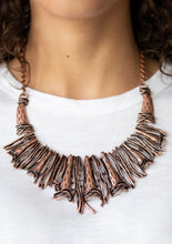 Load image into Gallery viewer, Brushed in an antiqued shimmer, a collision of glistening copper bars and hammered copper accents coalesce into an abstract statement piece below the collar for a fierce industrial look. Features an adjustable clasp closure.  Sold as one individual necklace. Includes one pair of matching earrings.