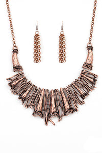 Brushed in an antiqued shimmer, a collision of glistening copper bars and hammered copper accents coalesce into an abstract statement piece below the collar for a fierce industrial look. Features an adjustable clasp closure.  Sold as one individual necklace. Includes one pair of matching earrings.