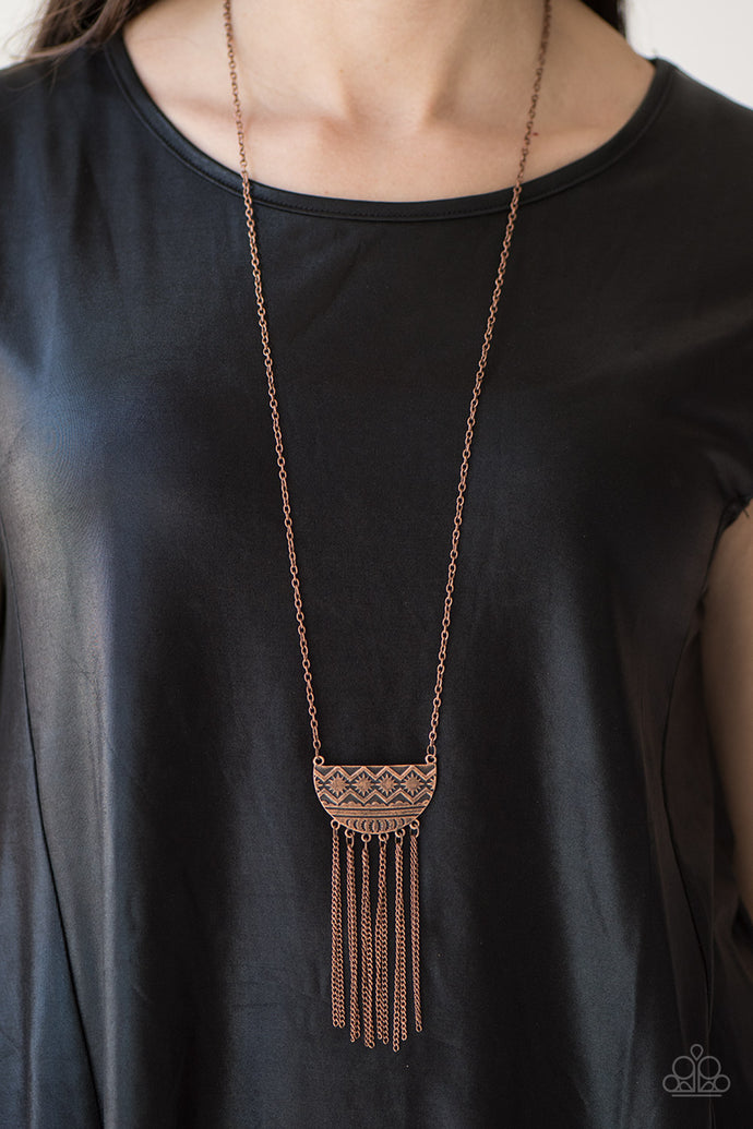Embossed in radiating sunburst patterns, a tribal inspired pendant swings from the bottom of a glistening copper chain for a seasonal look. Dainty copper chains stream from the bottom of the crescent-shaped pendant, adding a wanderlust vibe to the indigenous look. Features an adjustable clasp closure.  Sold as one individual necklace. Includes one pair of matching earrings.