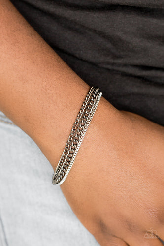 Dainty silver box chain and mismatched gunmetal chains layer across the wrist, creating a collision of industrial textures. Features an adjustable clasp closure.  Sold as one individual bracelet.  Always nickel and lead free.