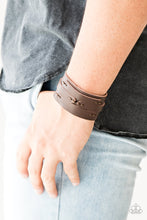 Load image into Gallery viewer, Pieces of brown leather are stitched in place across the front of a thick brown leather band for a rugged look. Features an adjustable snap closure.  Sold as one individual bracelet.  Always nickel and lead free. 