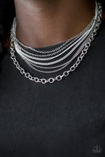 Load image into Gallery viewer, Painted in a neutral finish, shiny white chains join a collision of silver chains below the collar for a daring industrial look. Features an adjustable clasp closure.  Sold as one individual necklace. Includes one pair of matching earrings.  Always nickel and lead free.