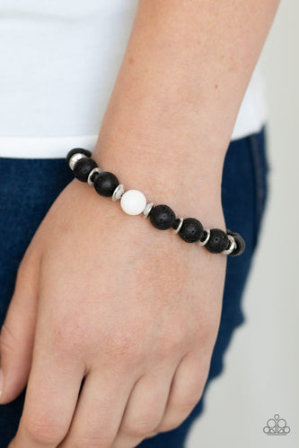 Essential Oil Alert!!  An earthy collection of shiny silver accents, black lava rock beads, and a single white stone bead is threaded along a stretchy band around the wrist for a seasonal flair. Sold as one individual bracelet.  Always nickel and lead free.  Item #P9SE-URWT-074XX