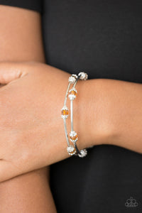 Dainty orange crystal-like beads and shimmery silver accents alternate along a coiled wire to create a refined infinity wrap style bracelet.  Sold as one individual bracelet.  Always nickel and lead free.