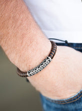 Load image into Gallery viewer, Brown and black cording knots around a leather cord, creating a colorful urban piece around the wrist. An ornate silver bead slides along the colorful strand, creating a bold centerpiece. Features an adjustable sliding knot closure.  Sold as one individual bracelet.  
