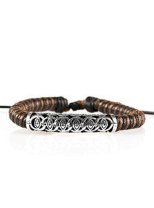 Brown and black cording knots around a leather cord, creating a colorful urban piece around the wrist. An ornate silver bead slides along the colorful strand, creating a bold centerpiece. Features an adjustable sliding knot closure. Sold as one individual bracelet.