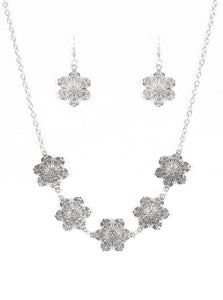 Featuring filigree filled petals, glistening silver flowers link below the collar in a seasonal fashion. Features an adjustable clasp closure.  Sold as one individual necklace. Includes one pair of matching earrings.