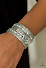 Load image into Gallery viewer, Brushed in a metallic shimmer, strips of green leather are encrusted in alternating rows of glittery white rhinestones. Green cording knots around the centermost strand, securing a sparkling heart frame in place for a whimsical finish. Features an adjustable clasp closure.  Sold as one individual bracelet.  Always nickel and lead free.