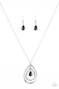 Delicately hammered, two glistening silver teardrops swing from the bottom of a shimmery silver chain. A faceted black bead dangles in the center of the teardrop pendants as the largest frame is encrusted in dazzling white rhinestones for a radiant finish. Features an adjustable clasp closure.  Sold as one individual necklace. Includes one pair of matching earrings.
