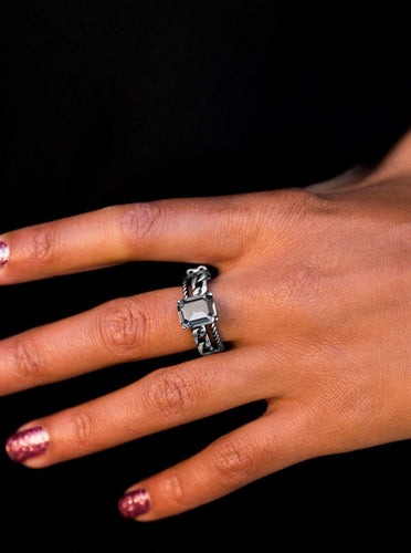 Featuring an elegant emerald style cut, a smoky rhinestone sits atop an asymmetrical silver band featuring chain-like textures. Features a dainty stretchy band for a flexible fit.  Sold as one individual ring.