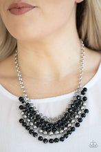 Load image into Gallery viewer, A colorful cascade of polished black and shimmery silver beads dangle from interlocking silver chains, creating a stacked fringe below the collar. Features an adjustable clasp closure.  Sold as one individual necklace. Includes one pair of matching earrings. 