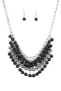 A colorful cascade of polished black and shimmery silver beads dangle from interlocking silver chains, creating a stacked fringe below the collar. Features an adjustable clasp closure.  Sold as one individual necklace. Includes one pair of matching earrings.