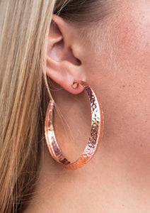 A thick copper hoop creases at the center, creating a chic 3-dimensional display. Finished in a hammered surface, the antiqued design evokes an indigenous inspired style. Earring attaches to standard post fitting. Hoop measures 2 1/4" in diameter.  Sold as one pair of hoop earrings.  