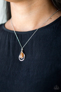 Chiseled into a tranquil teardrop, a glowing brown moonstone is pressed into an abstract silver frame, creating a whimsical pendant. Features an adjustable clasp closure.  Sold as one individual necklace. Includes one pair of matching earrings.  Always nickel and lead free.