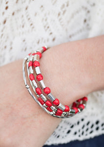 Brushed in a faux rock finish, dainty red beading and shimmery silver accents alternate along a coiled wire to create an earthy infinity wrap style bracelet.  Sold as one individual bracelet.