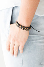 Load image into Gallery viewer, Shiny black and brown cording weaves together, creating a knotted braid across the wrist. Features an adjustable sliding knot closure.  Sold as one individual bracelet.  Always nickel and lead free.