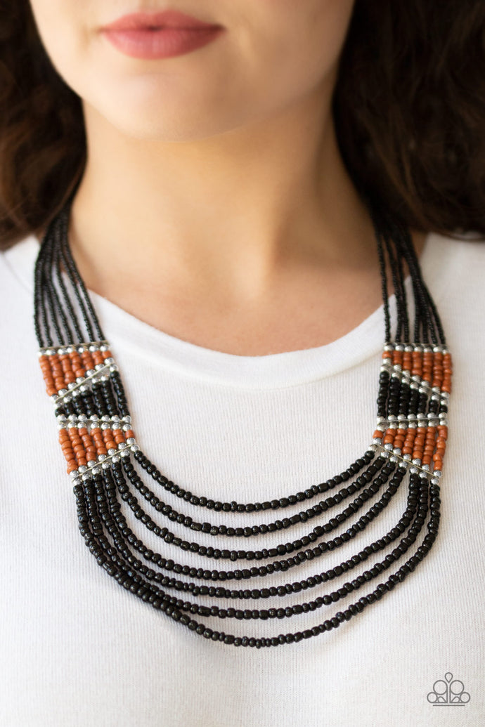 Separated by shimmery silver fittings, black, brown, and silver seed beaded geometric frames give way to layers of black seed beads down the chest for a tribal inspired flair. Features an adjustable clasp closure.  Sold as one individual necklace and earring set.  Always nickel and lead free!