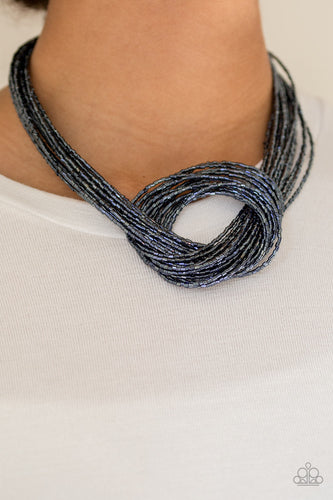Countless strands of metallic blue seed beads delicately knot together below the collar to create an unforgettable statement piece. Features an adjustable clasp closure.  Sold as one individual necklace. Includes one pair of matching earrings.  Always nickel and lead free.