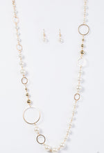 Load image into Gallery viewer, Luminescent pearls and classic gold beads join shimmery gold hoops along a gold chain for a timeless look. Features an adjustable clasp closure.  Sold as one individual necklace. Includes one pair of matching earrings.