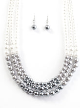 Load image into Gallery viewer, Strands of white, silver, and dark gray pearls elegantly drape below the collar, creating a beautiful hombre effect. Sectioned by silver accents, the luminescent pearls radiantly fall into a glamorous cascade. Features an adjustable clasp closure.  Sold as one individual necklace. Includes one pair of matching earrings.