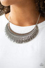 Load image into Gallery viewer, Stamped in an assortment of geometric patterns, an oversized silver half-moon pendant swings below the collar for a bold tribal style. Features an adjustable clasp closure.  Sold as one individual necklace. Includes one pair of matching earrings. Always nickel and lead free.