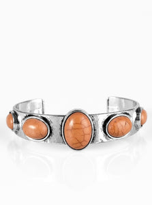Chiseled into smooth ovals, smooth brown stone beads are pressed into an antiqued silver cuff for a handcrafted, artisanal look.  Sold as one individual bracelet.