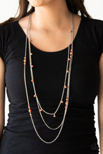 Load image into Gallery viewer, Infused with a plain silver chain, mismatched orange stone beads sporadically trickle along shimmery silver chains, creating vivacious layers down the chest. Features an adjustable clasp closure.  Sold as one individual necklace. Includes one pair of matching earrings. Always nickel and lead free.