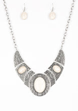 Load image into Gallery viewer, Radiating with studded and tribal inspired patterns, antiqued silver plates connect below the collar for a fierce look. Refreshing white stones are pressed into the plates, adding an artisan flair to the dramatic centerpiece. Features an adjustable clasp closure.  Sold as one individual necklace. Includes one pair of matching earrings