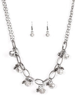Load image into Gallery viewer, Featuring a smoky shimmer, faceted beads swing from the bottom of bold gunmetal links. Clusters of faceted gunmetal beads join the glassy gems, creating a dramatic fringe below the collar. Features an adjustable clasp closure.  Sold as one individual necklace. Includes one pair of matching earrings.