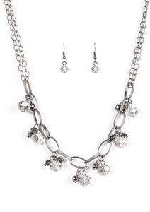 Featuring a smoky shimmer, faceted beads swing from the bottom of bold gunmetal links. Clusters of faceted gunmetal beads join the glassy gems, creating a dramatic fringe below the collar. Features an adjustable clasp closure.  Sold as one individual necklace. Includes one pair of matching earrings.