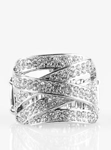 Encrusted in rows of glittery white rhinestones, shimmery silver ribbons crisscross across the finger, creating a blinding centerpiece. Features a stretchy band for a flexible fit.  Sold as one individual ring.