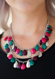 Two strands of silver chain are decorated in a flirtatious fringe of faceted green, pink, and plum teardrops. Glittery beveled silver teardrops are sprinkled between the colorful beading, adding hints of shimmer to the vibrant design. Features an adjustable clasp closure.  Sold as one individual necklace. Includes one pair of matching earrings.  