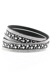 Bubbly silver studs, and rows of glittery white rhinestones are encrusted along strips of black suede. The elongated design allows for a trendy double wrap around the wrist. Features an adjustable snap closure.  Sold as one individual bracelet.