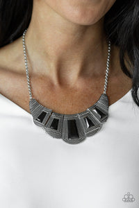 Featuring faceted emerald style cuts, bold geometric black beads are pressed into studded silver frames that dramatically link below the collar for a fierce finish. Features an adjustable clasp closure.  Sold as one individual necklace. Includes one pair of matching earrings.  Always nickel and lead free.