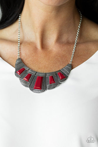 Featuring faceted emerald style cuts, bold geometric red beads are pressed into studded silver frames that dramatically link below the collar for a fierce finish. Features an adjustable clasp closure.  Sold as one individual necklace. Includes one pair of matching earrings.  Always nickel and lead free.