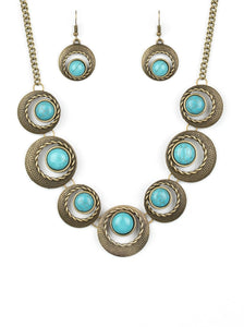 ﻿Featuring refreshing turquoise stone accents, hammered and textured circular frames link below the collar for an artisan inspired look. Features an adjustable clasp closure.  Sold as one individual necklace. Includes one pair of matching earrings.