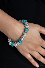 Load image into Gallery viewer, A collection of faceted blue beads, ornate silver beads, and studded silver rings are threaded along a stretchy band around the wrist for a colorfully refined look.  Sold as one individual bracelet.  Always nickel and lead free.
