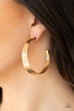 Load image into Gallery viewer, Attached to two gold fittings, wire after wire stacks into an edgy hoop. Earring attaches to a standard post fitting. Hoop measures 2&quot; in diameter.  Sold as one pair of hoop earrings.  Always nickel and lead free.