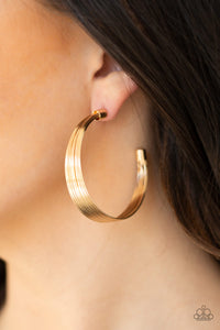 Attached to two gold fittings, wire after wire stacks into an edgy hoop. Earring attaches to a standard post fitting. Hoop measures 2" in diameter.  Sold as one pair of hoop earrings.  Always nickel and lead free.